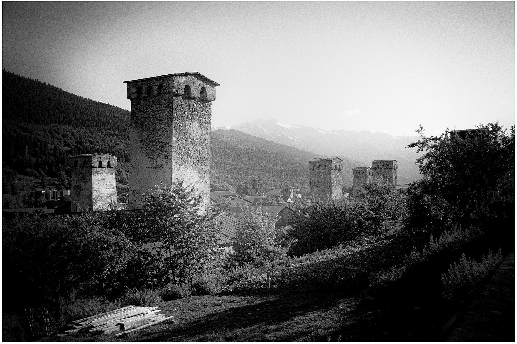 Svan stone towers in Mestia beneath the Caucasus mountains during a Svaneti hiking tour
