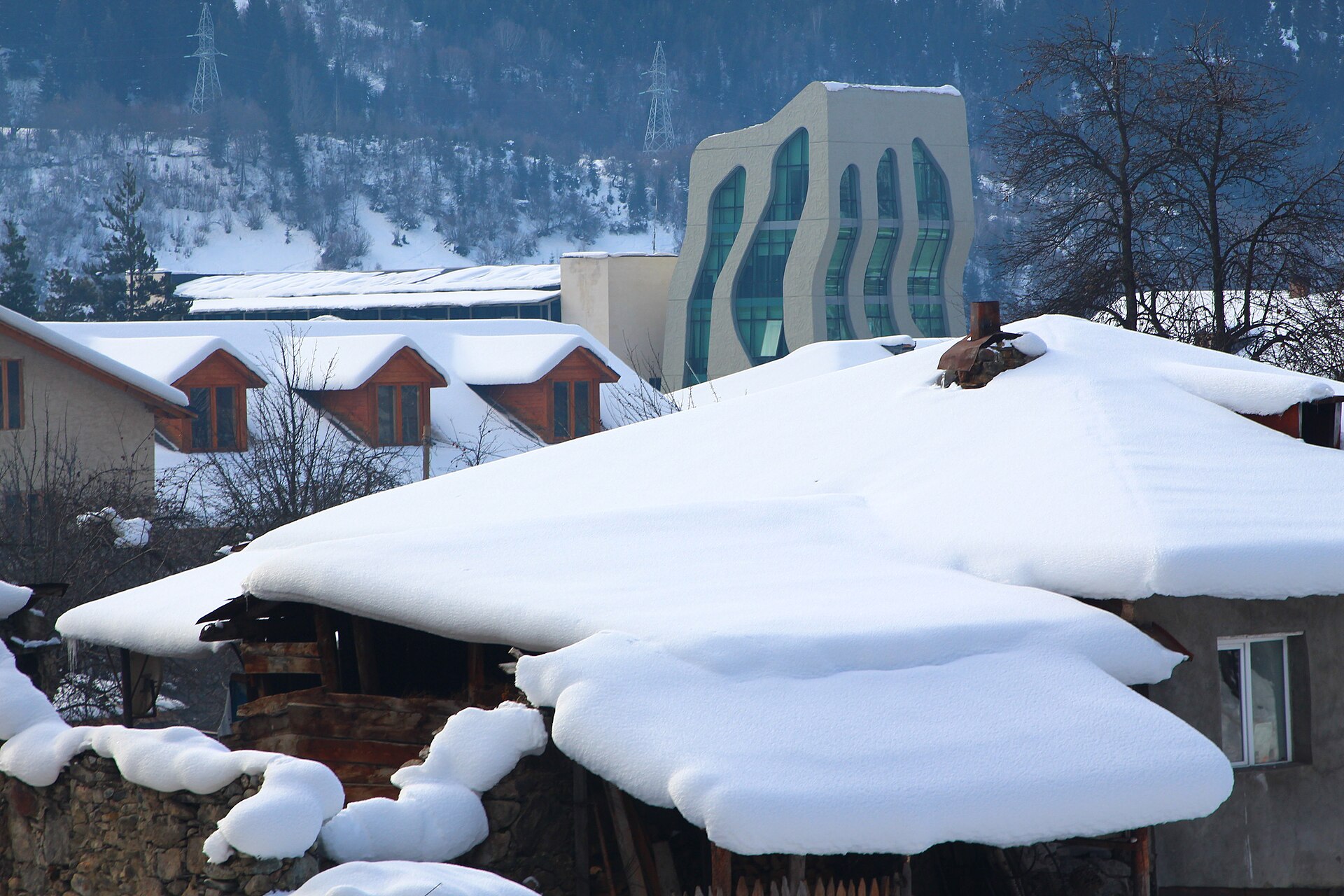 Mestia in deep winter snow with the Caucasus range behind, Svaneti, Georgia